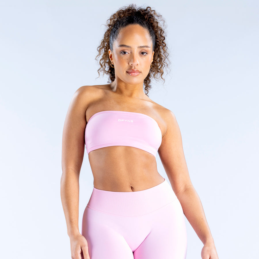 Pink bandeau sports bra with wide band and seamless, fitted front