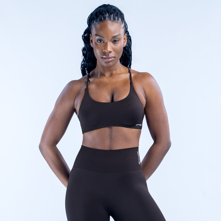 Black twist-back sports bra with thin shoulder straps and scoop neckline