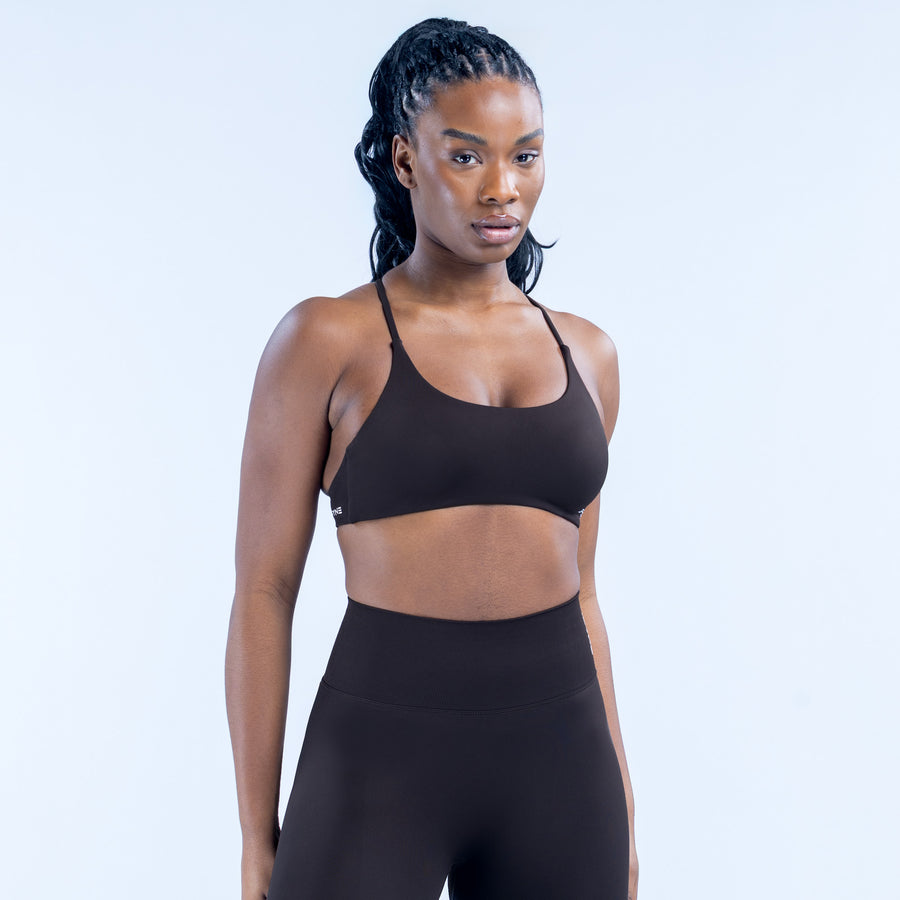 Black twist-back sports bra with simple front straps and fitted cups