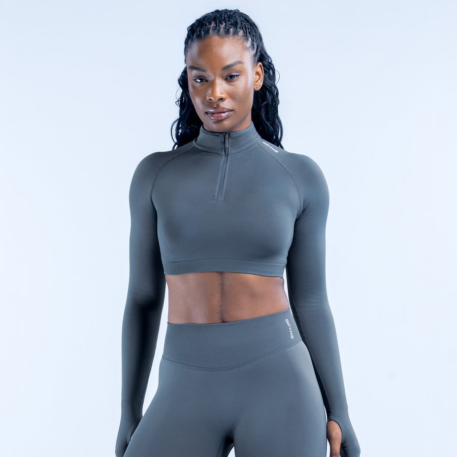 Dark gray cropped long-sleeve athletic top with quarter-zip and high collar