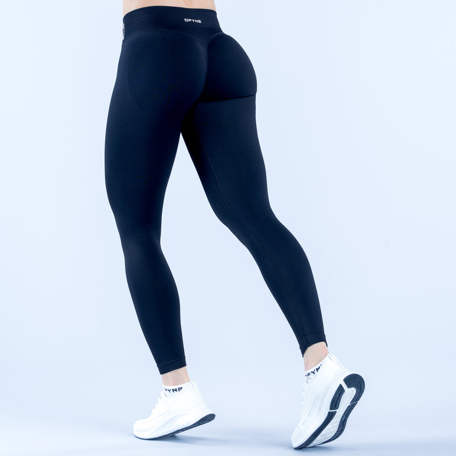 High-rise dark navy leggings, back view with contoured hip and knee panels
