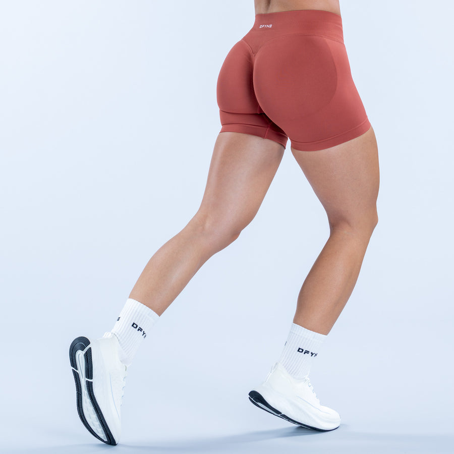 4.5-inch impact shorts in rust red, rear view with curved seam