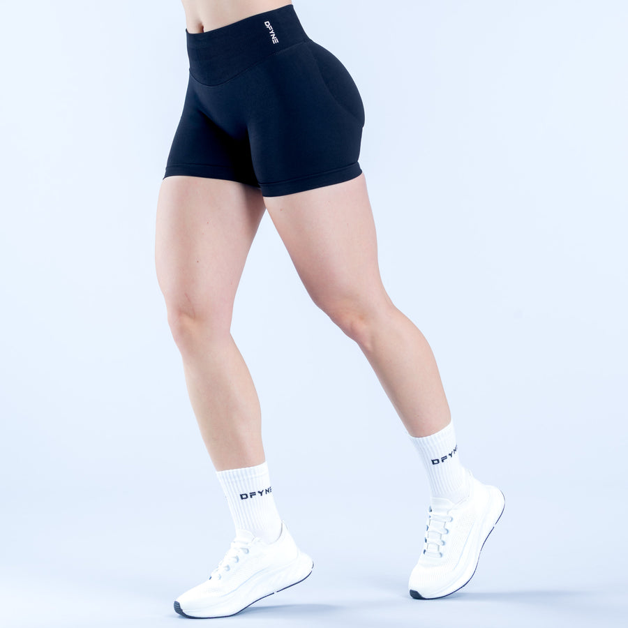 Black 4.5-inch impact shorts, side view, contoured seams and wide waistband