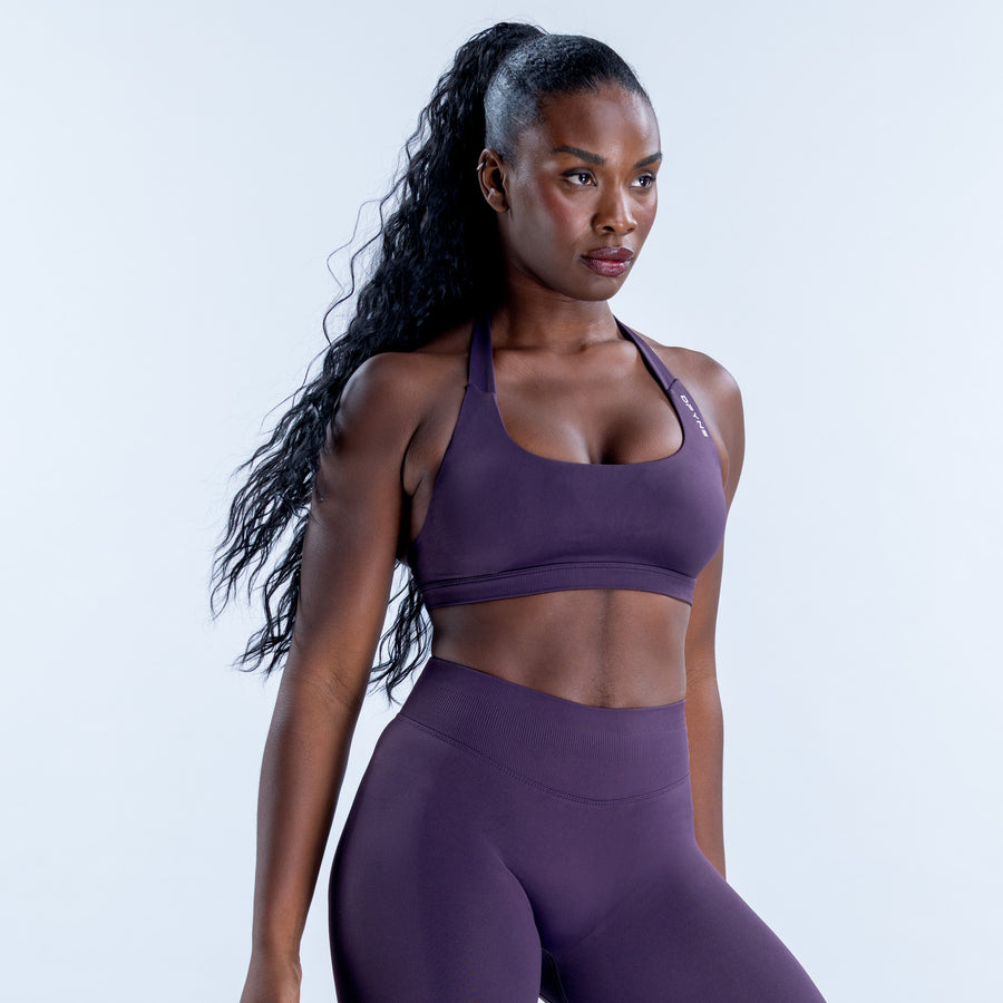 Front view of a purple impact sports bra with a scoop neckline and slim shoulder straps.