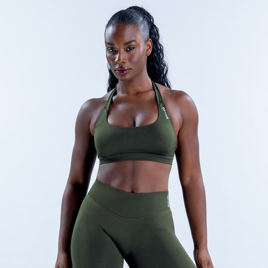 Front view of a dark olive sports bra with a scoop neckline and halter straps.