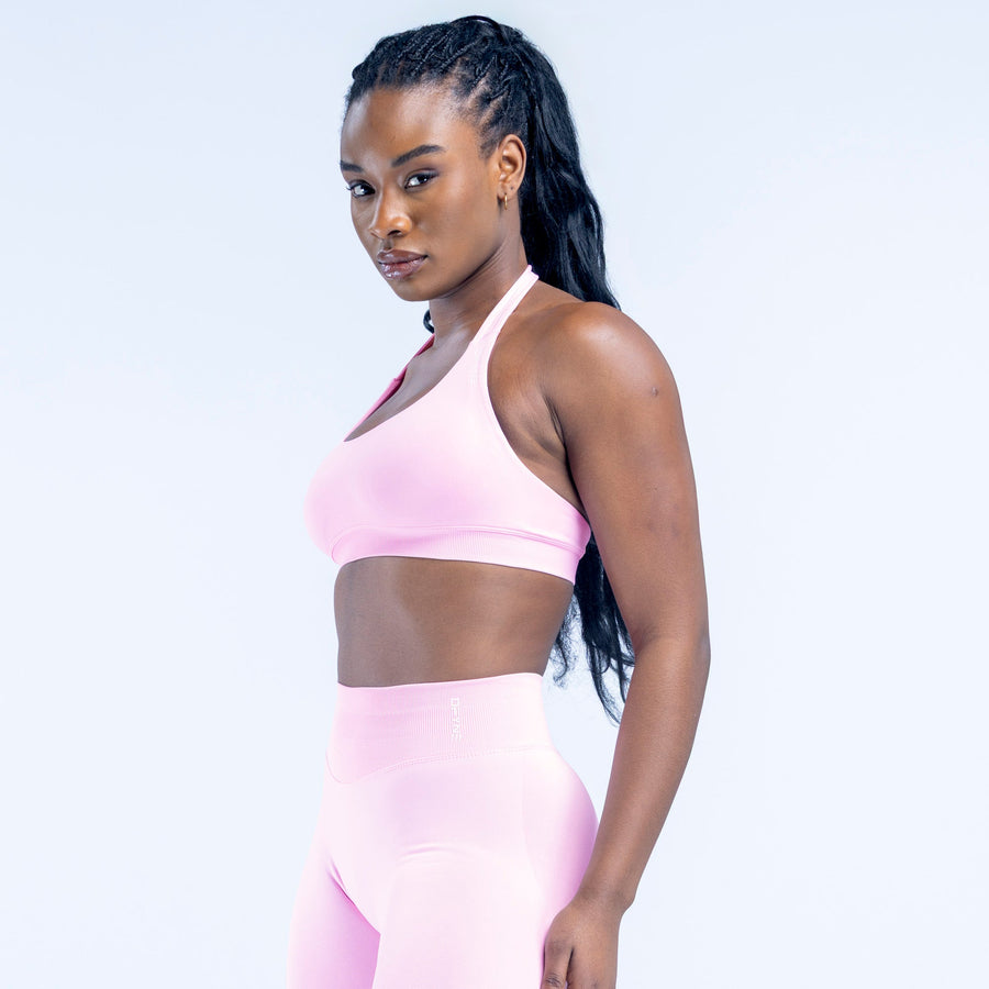 Light pink racerback sports bra with smooth fabric and supportive band