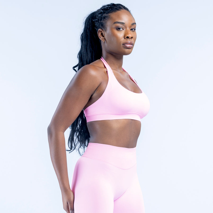 Light pink high-support sports bra with wide straps and smooth racerback