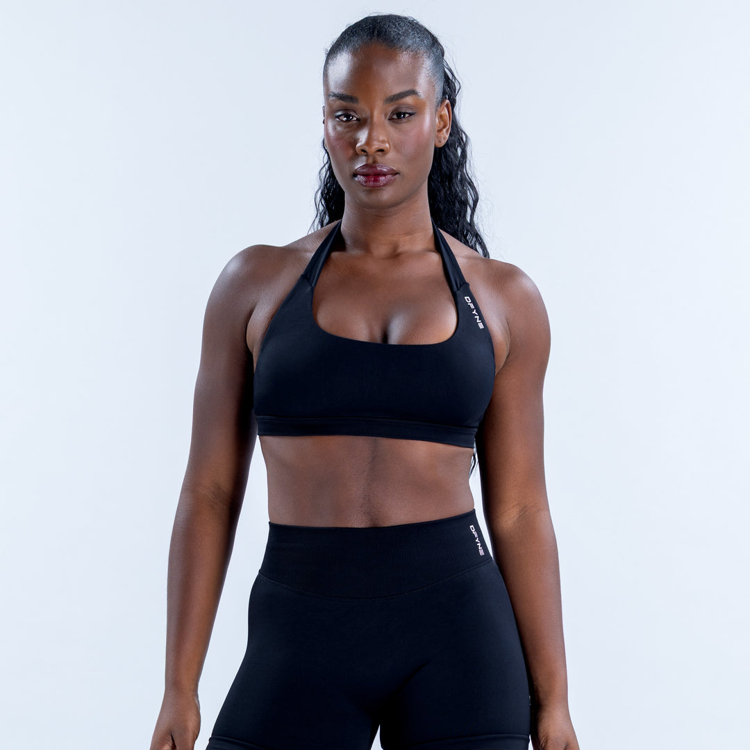 Black Impact Sports Bra with a halter neckline and wide underbust band, front view