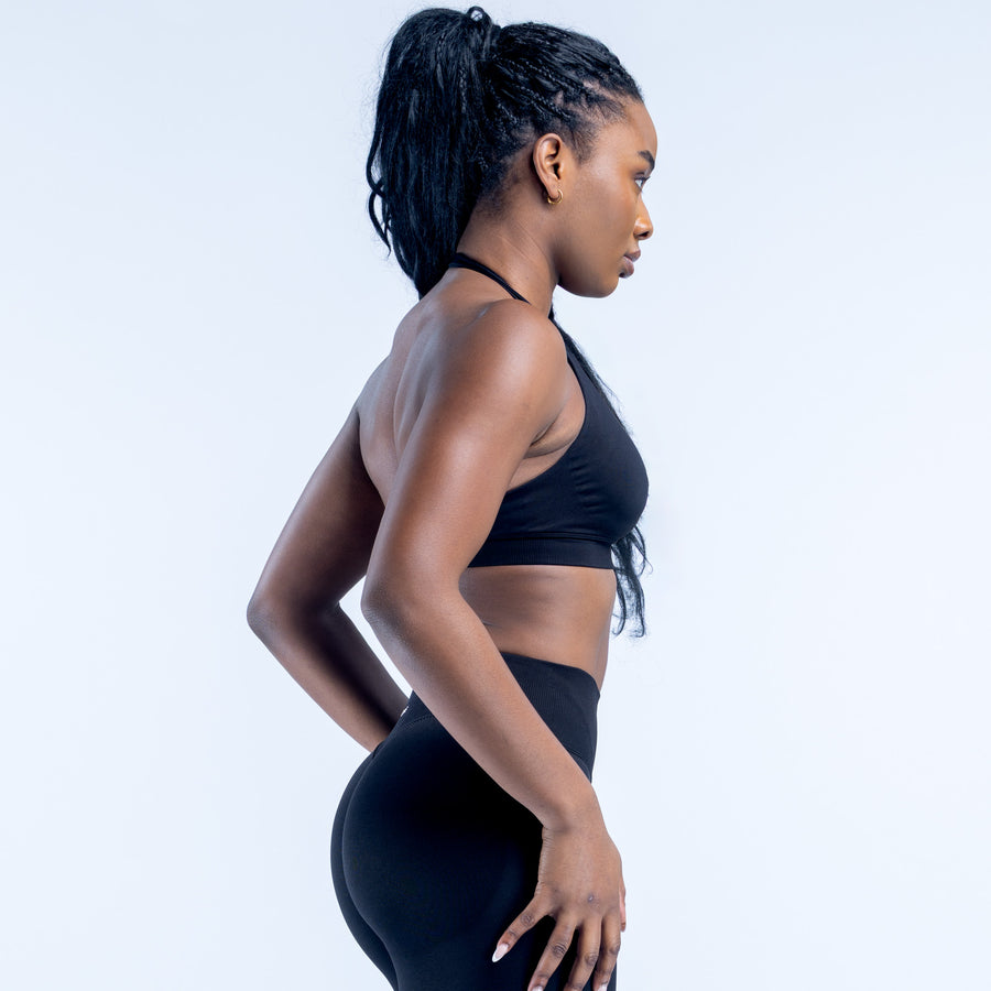 Black impact sports bra with racerback straps and smooth midsection panel