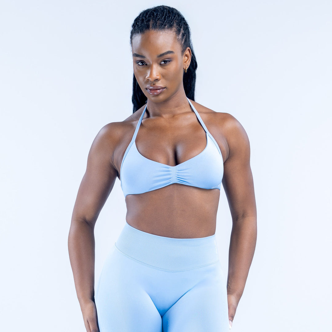 Light blue strappy impact bra with ruched center front and halter-style straps