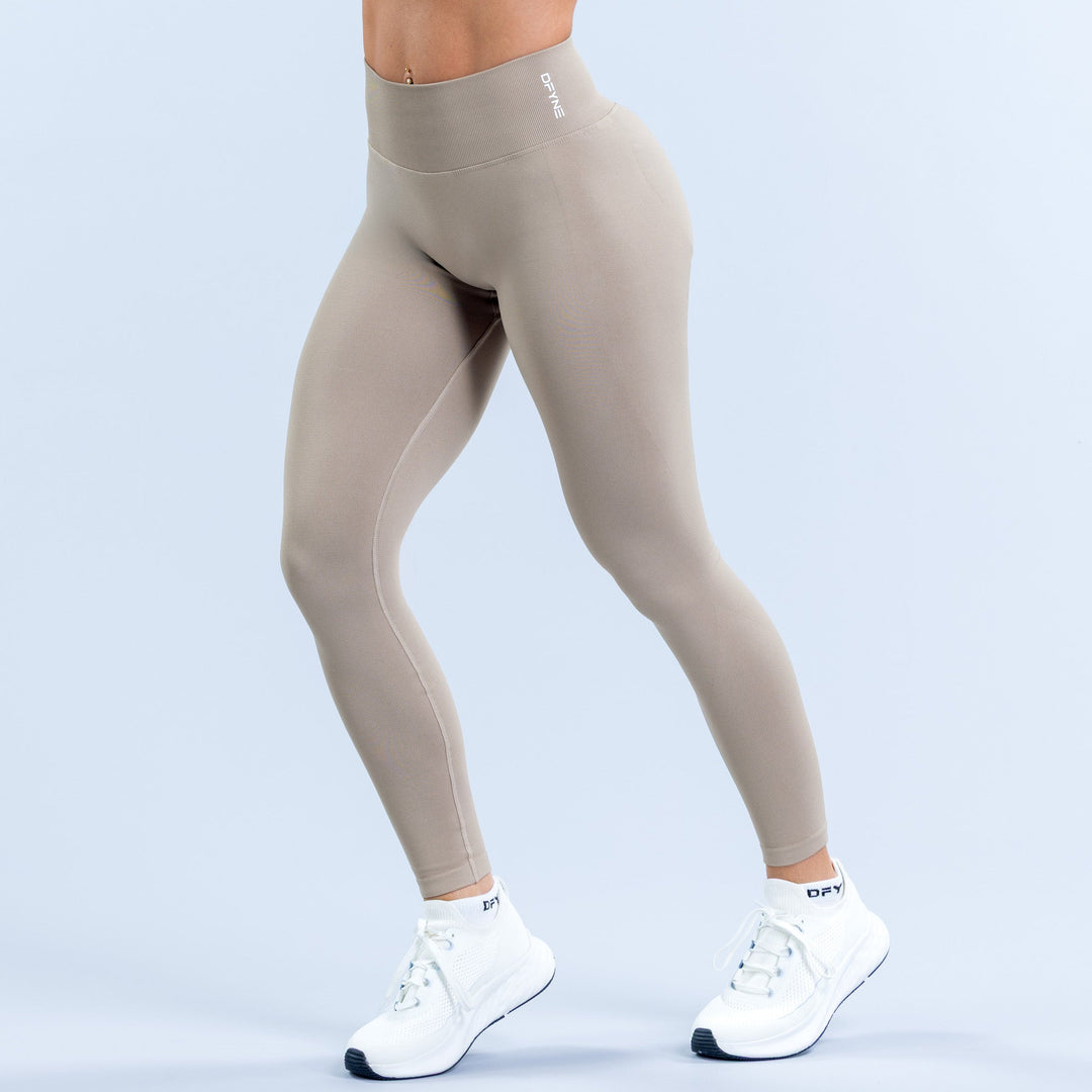 Women's light taupe leggings with waistband logo and full-length fit