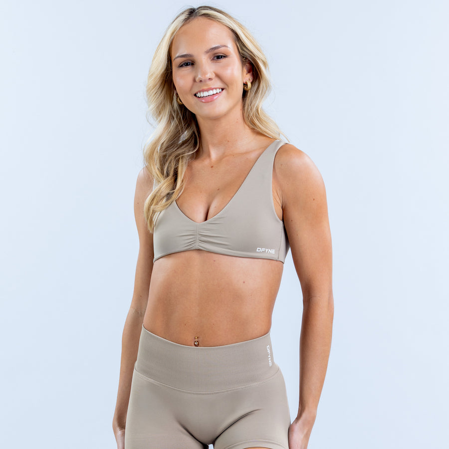 Women’s minimal bra in light taupe with smooth cups and small front logo
