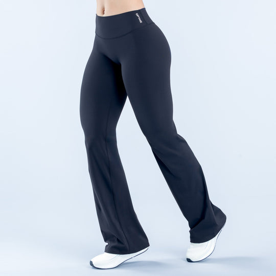 High-waist black flare leggings, fitted hips and thighs, wide bootcut