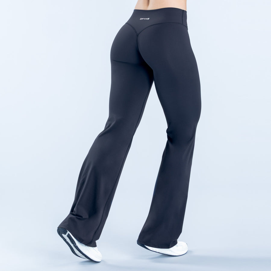 Dark flared leggings with high-rise waistband and smooth stretch fit, flared at ankle.