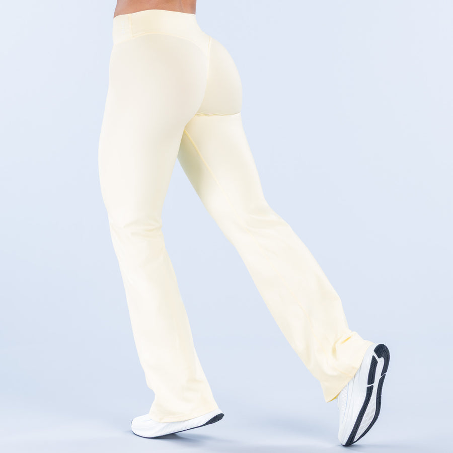 Light yellow flared pants, back view with smooth seam and wide bootcut hem