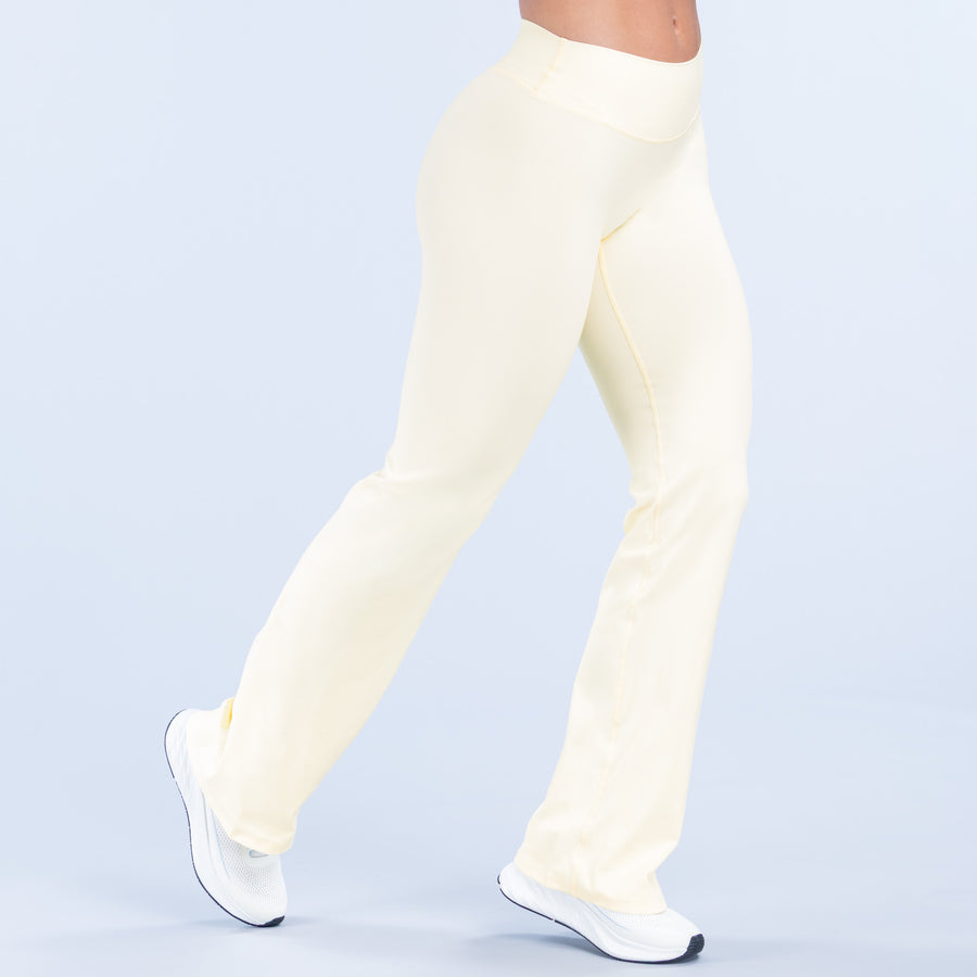Light yellow flared pants, side view with high rise and wide leg opening
