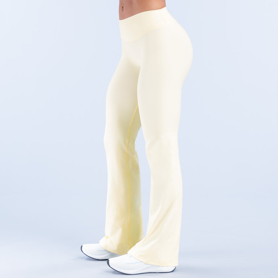 Light yellow flared pants, full length side view with wide bell bottom