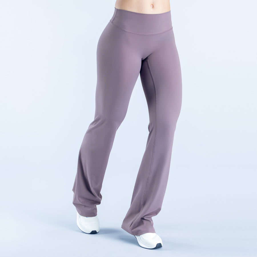 High-waist mauve flared leggings with tapered fit and wide cuffed hem.
