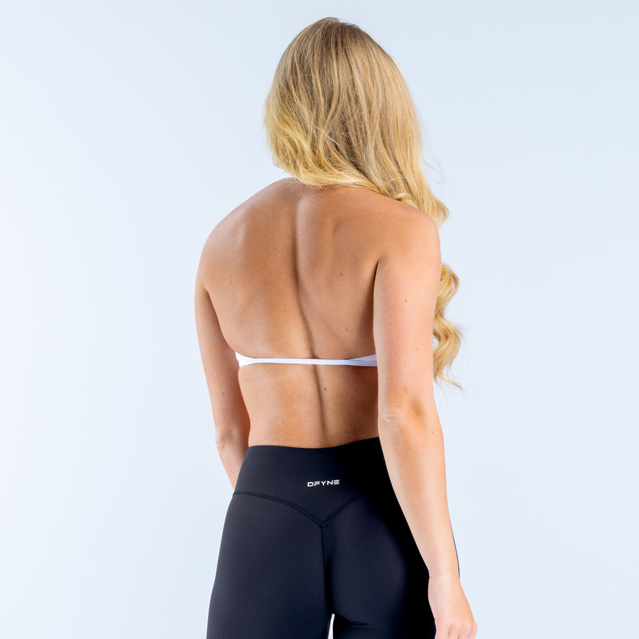 White halter bra back view with halter straps and V-back neckline, small logo