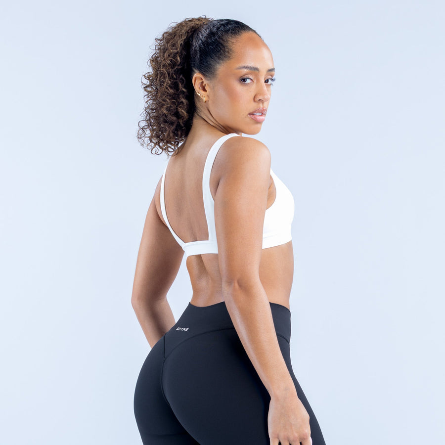 White minimal sports bra with racerback straps, back view