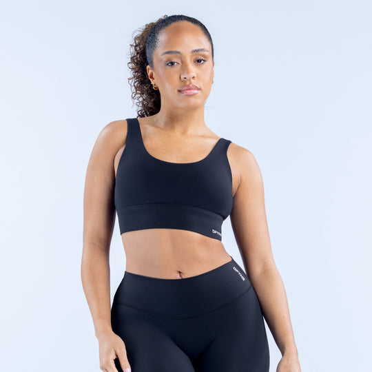 Black racerback sports bra with wide bottom band, medium support