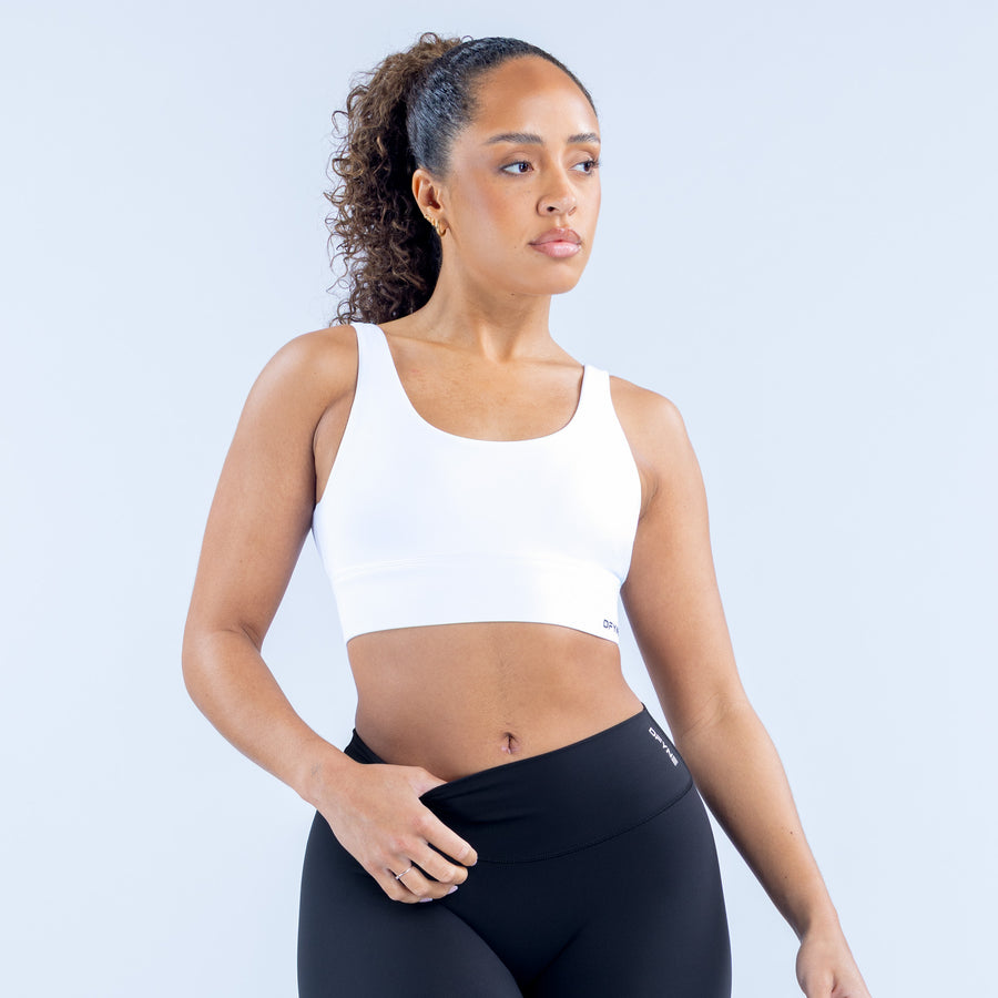 White racerback sports bra with wide underband and scoop neckline