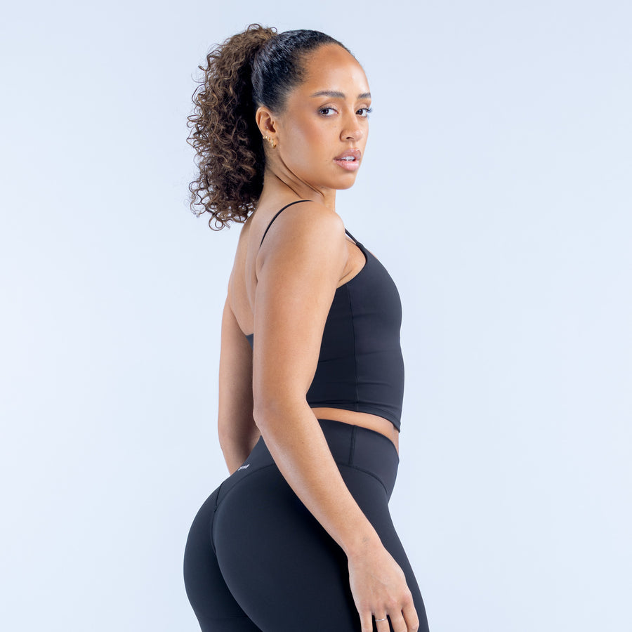 Strappy top on side profile, thin straps and scoop neckline, dark fitted cropped