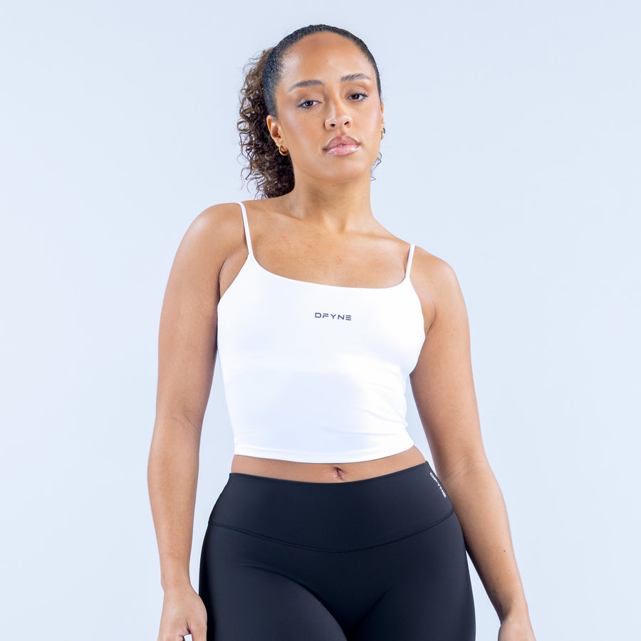 White strappy crop top with thin straps and square neckline, centered chest logo
