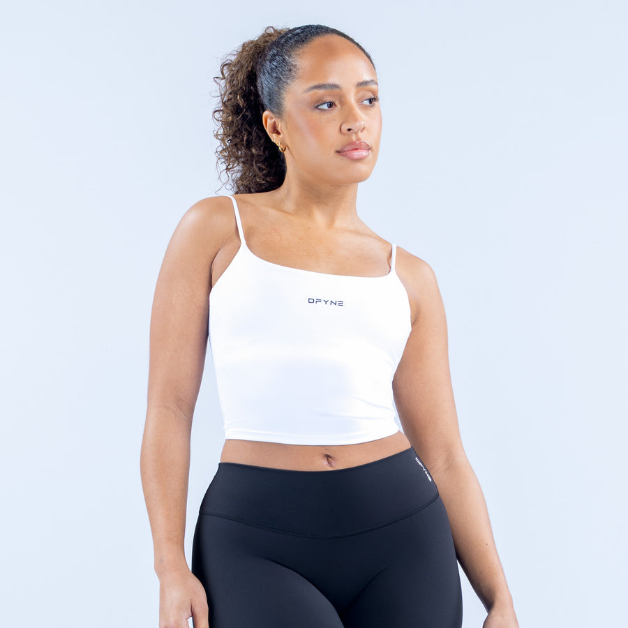 White strappy crop top with thin straps and square neckline, small logo on chest