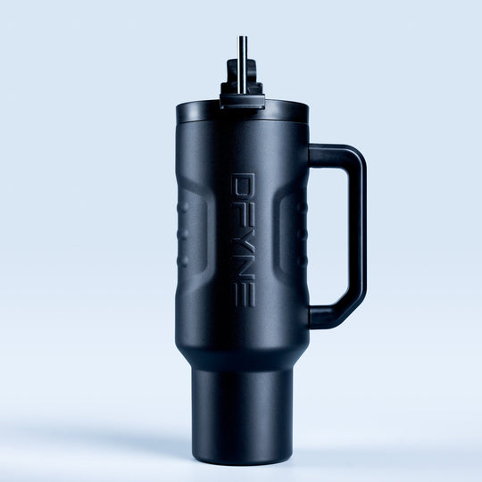 Insulated black drink tumbler with handle and straw, side view