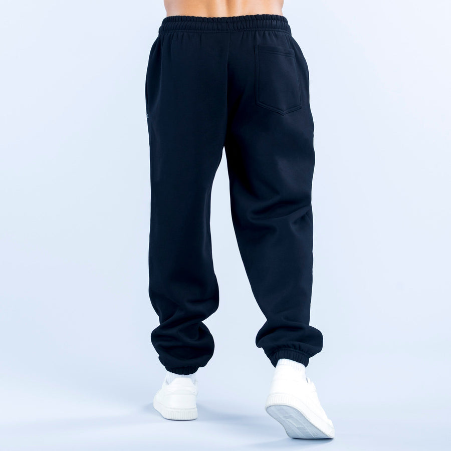 Dark navy joggers with elastic waist, cuffed hems, and a back pocket detail.