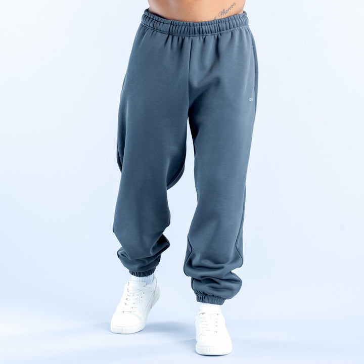 Dark blue joggers with elastic waistband and cuffed ankle, side pockets