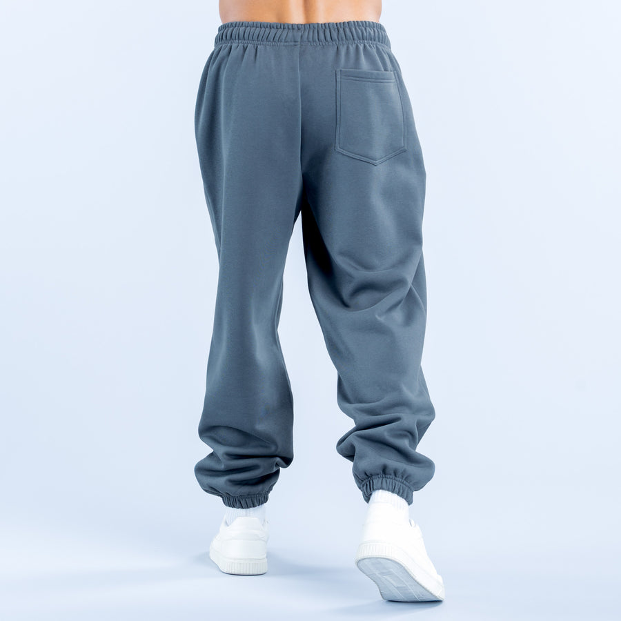Dark teal jogger pants with elastic waistband, tapered legs, cuffed hems, side pockets