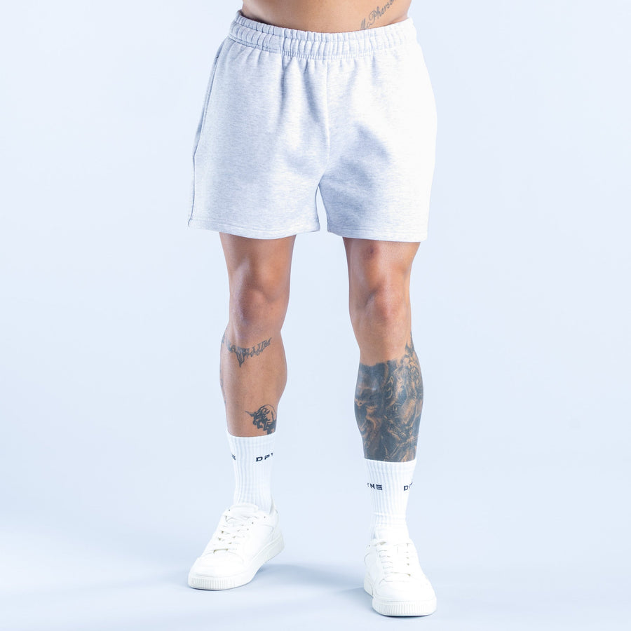 Light heather blue shorts with elastic waistband, above-knee length, standing view