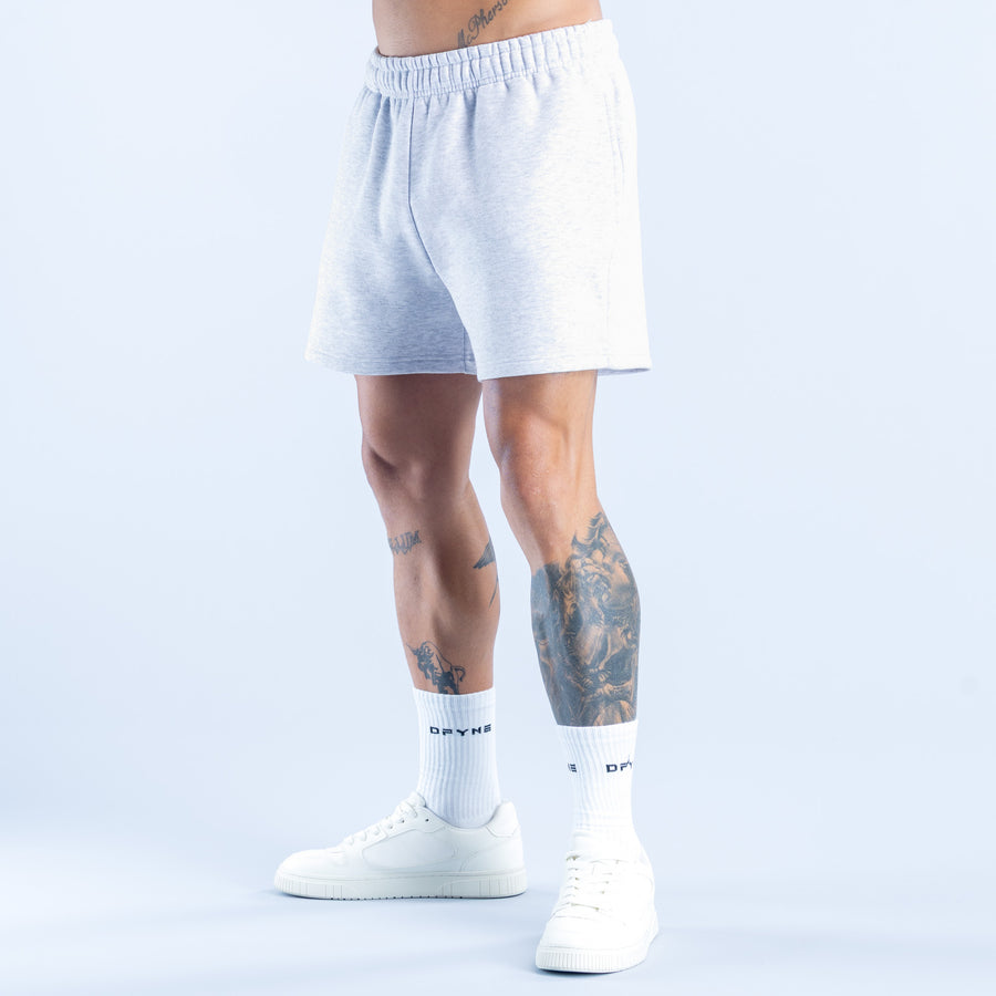 Light blue sweat shorts with elastic waistband, knee length, side pockets