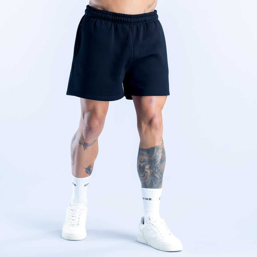 Dark navy athletic shorts with elastic waistband, mid-thigh length, small side logo