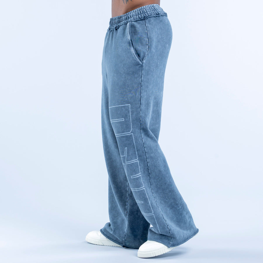 Washed jogger pants in blue wash with elastic waistband, back seam, and side graphic