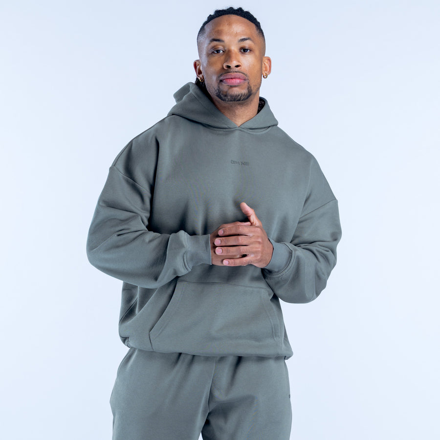 Olive graphic hoodie on model, hooded sweatshirt with front pocket