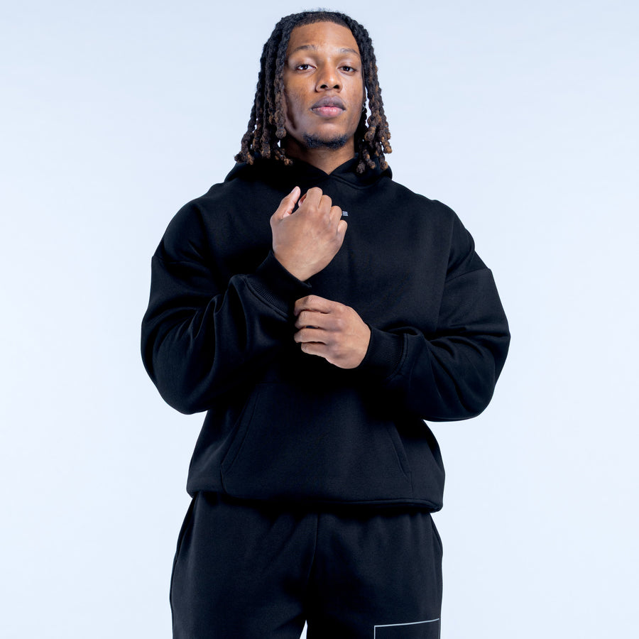 Black Recharge hoodie with hood and kangaroo pocket, drawstring at neckline.