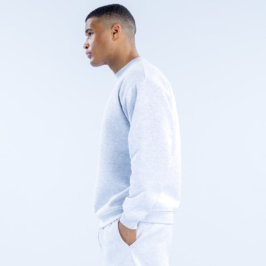 Light gray crewneck sweatshirt in side profile, long sleeves, ribbed hem