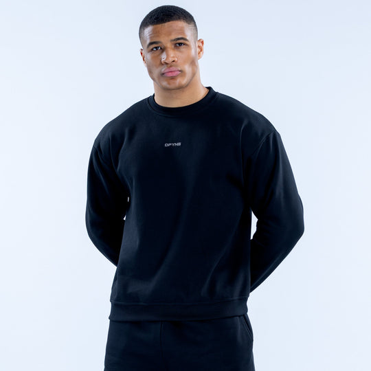 Black crewneck sweatshirt with small chest logo, ribbed cuffs and hem