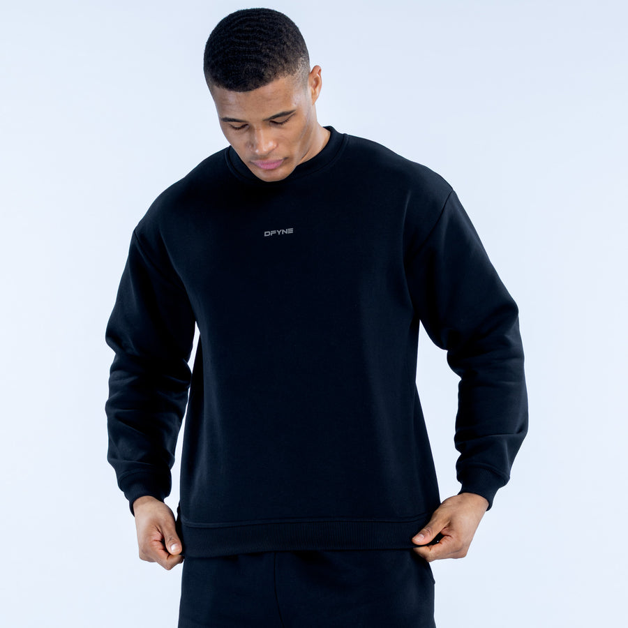 Dark crewneck sweatshirt with small chest logo, relaxed fit and ribbed hem