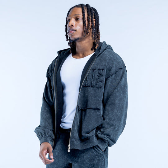 Dark gray washed zip hoodie with hood, flap pockets, and chest logo lettering