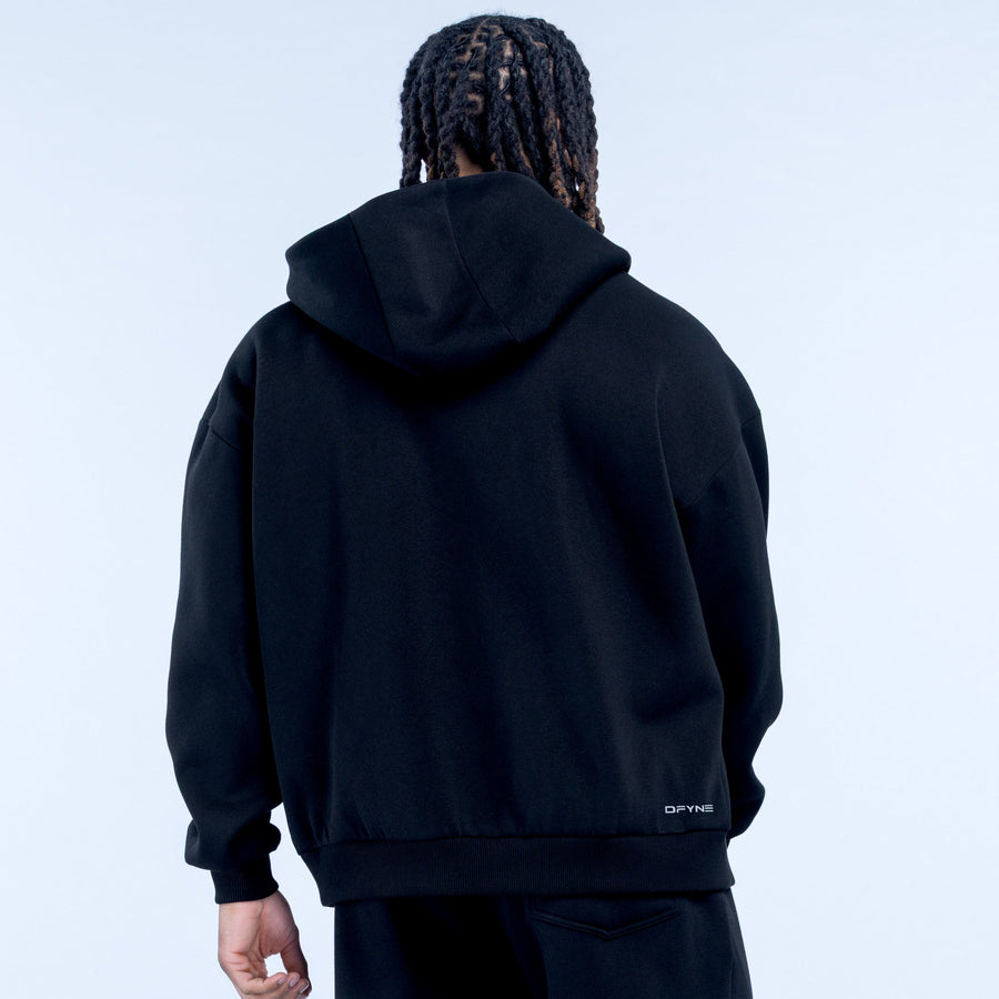 Black zip-up hoodie, rear view with hood, small logo at lower right hem