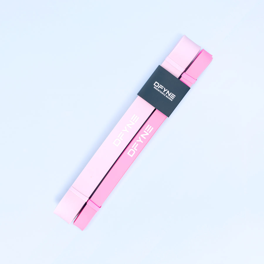 Pink resistance bands set with DRYNE branding on two loop bands