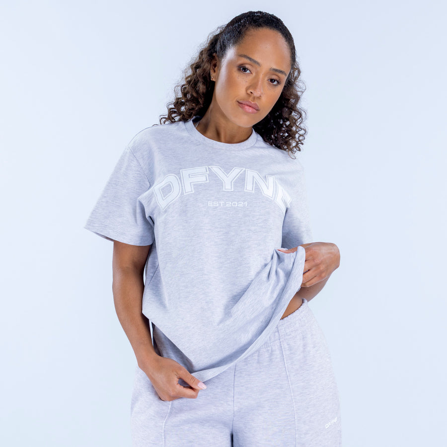 Light gray oversized graphic tee with large front logo print and crew neck