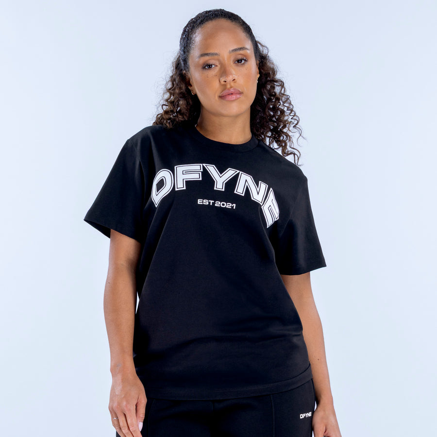 Black oversized graphic T-shirt with white “OFYN” logo across the chest