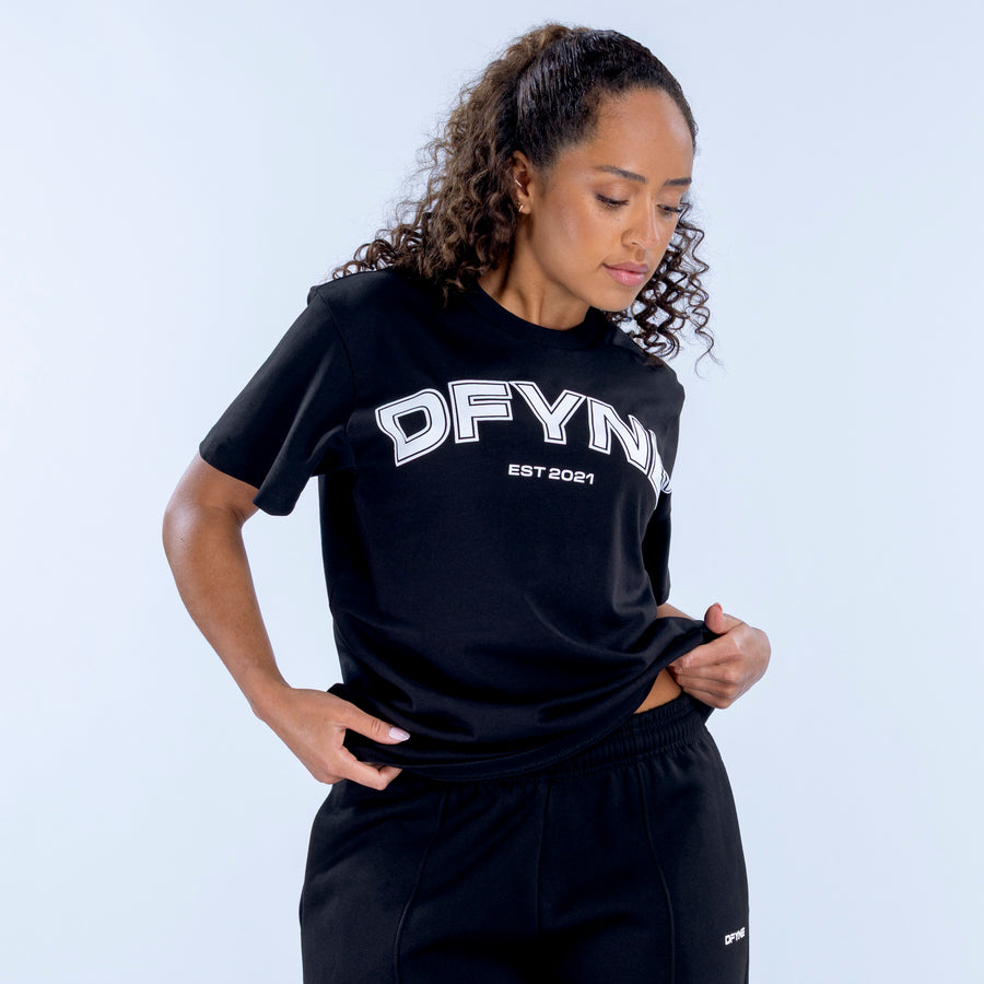 Black oversized tee with large white “OFYN” logo and “EST 2021” graphic