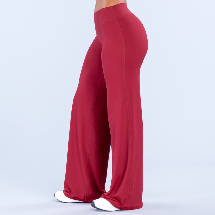 Red wide-leg pants, side view, high-rise waistband and long flared legs