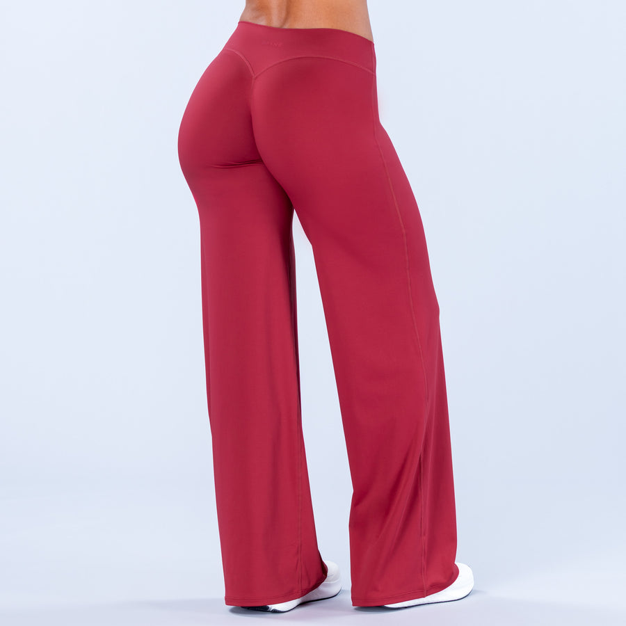 High-waist wide-leg pants, deep red; relaxed straight leg fit.